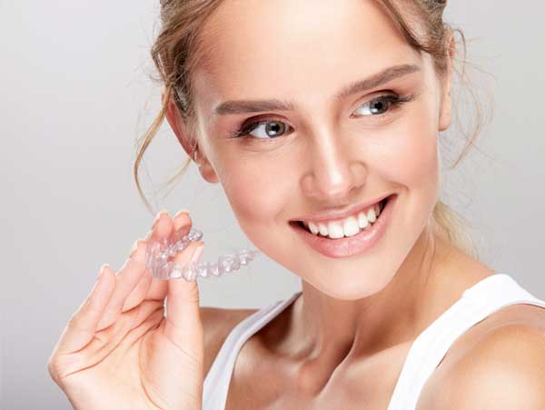 Girl Holding Invisalign Tray