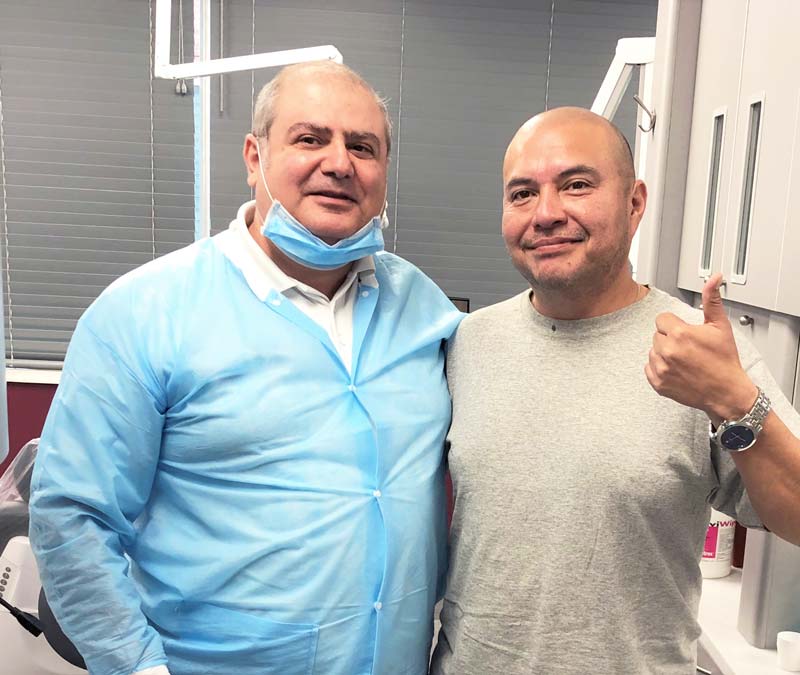 Northbrook Dentist Dr. Zomorrodi with a happy patient giving thumbs up